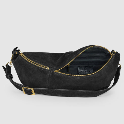 Open black suede bag showing dark lining and inner zip pocket