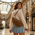 Mocha Genova bag styled across the body on a model outdoors