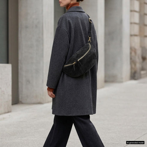 Black Genova bag styled across the body on a model outdoors