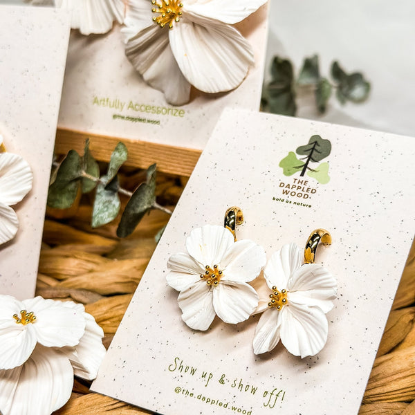 White sculpted Florita mini flower earrings on The Dappled Wood display cards