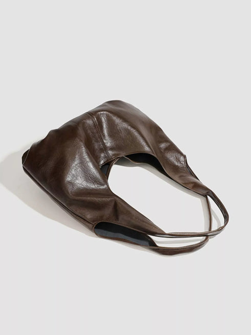 Brown Glossy Hobo Shoulder Bag with Matching Pouch: Brown hobo bag laid on its side