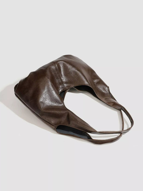 Brown Glossy Hobo Shoulder Bag with Matching Pouch: Brown hobo bag laid on its side, alternate view