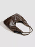 Brown Glossy Hobo Shoulder Bag with Matching Pouch: Brown hobo bag laid on its side, alternate view