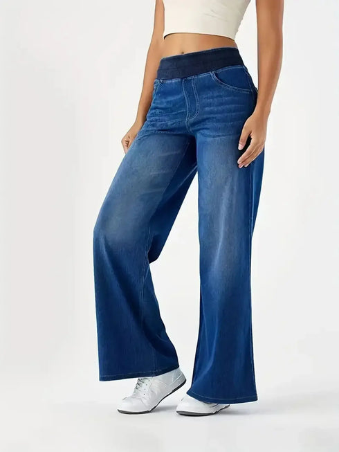 Angled view of blue elastic-waist jeans and front pockets