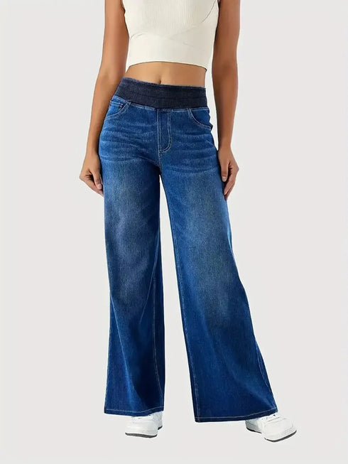 Front of blue jeans showing the wide waistband and loose legs