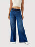 Front of blue jeans showing the wide waistband and loose legs