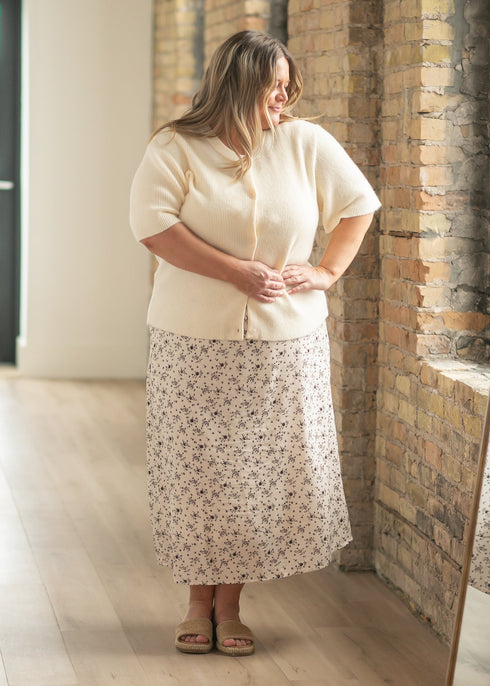 Ivory Zadie cardigan worn buttoned with a floral midi skirt