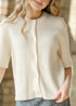 Close-up of the Zadie cardigan crew neckline, buttons and vertical ribbed knit