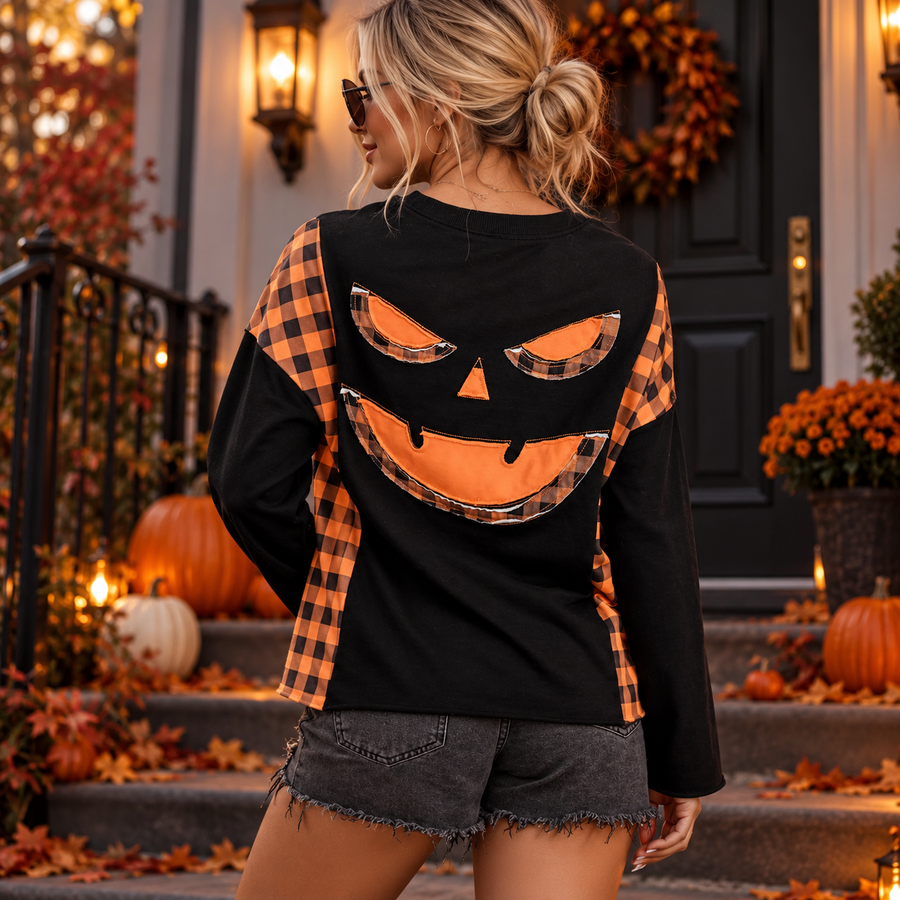 Women's Halloween Pumpkin Top: Black pumpkin-face top, back view styled outdoors